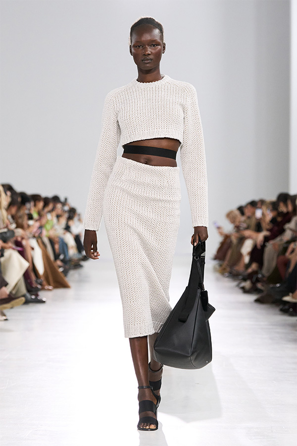 Max Mara Spring/Summer 2026 Fashion Show - White Look with cropped jumper paired with midi skirt and black bag.