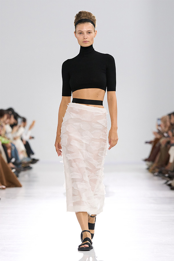 Max Mara Spring/Summer 2026 Fashion Show - Look with black Cropped Turtleneck and semi-transparent white Skirt.
